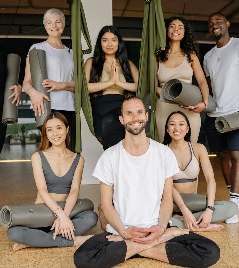 A diverse group of people feeling relaxed and happy after a yoga class.