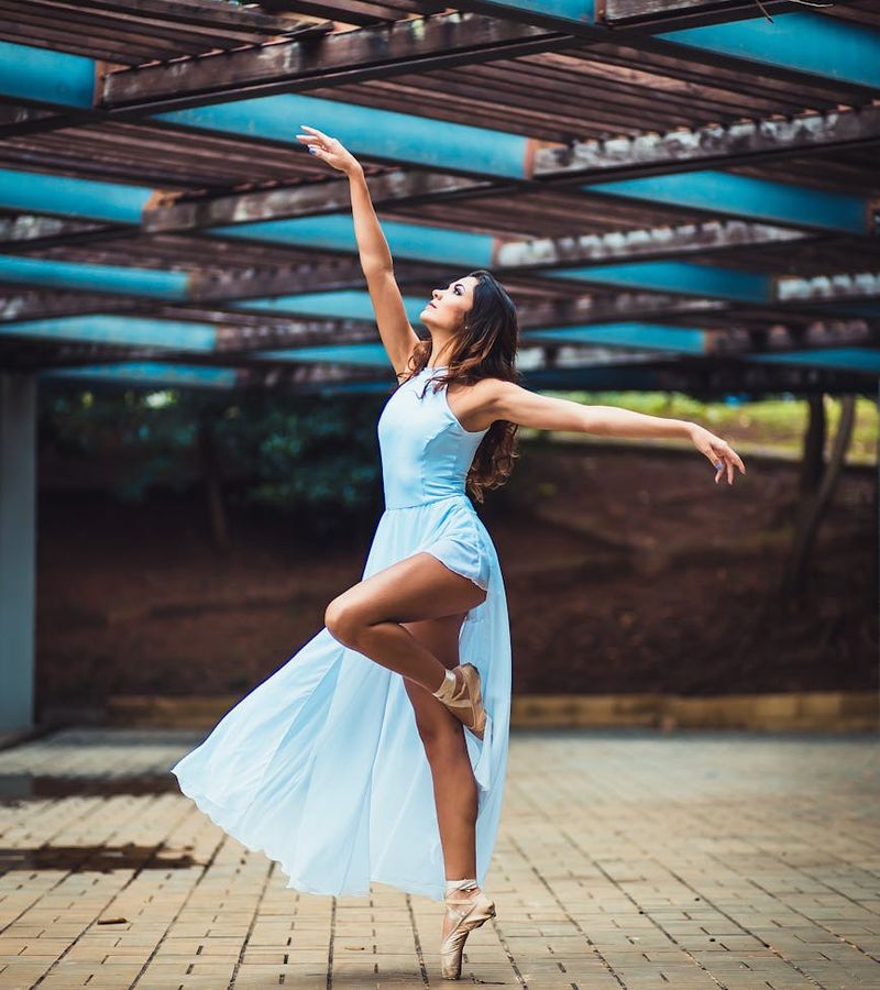 Person in a graceful flowing movement, symbolizing improved flexibility.