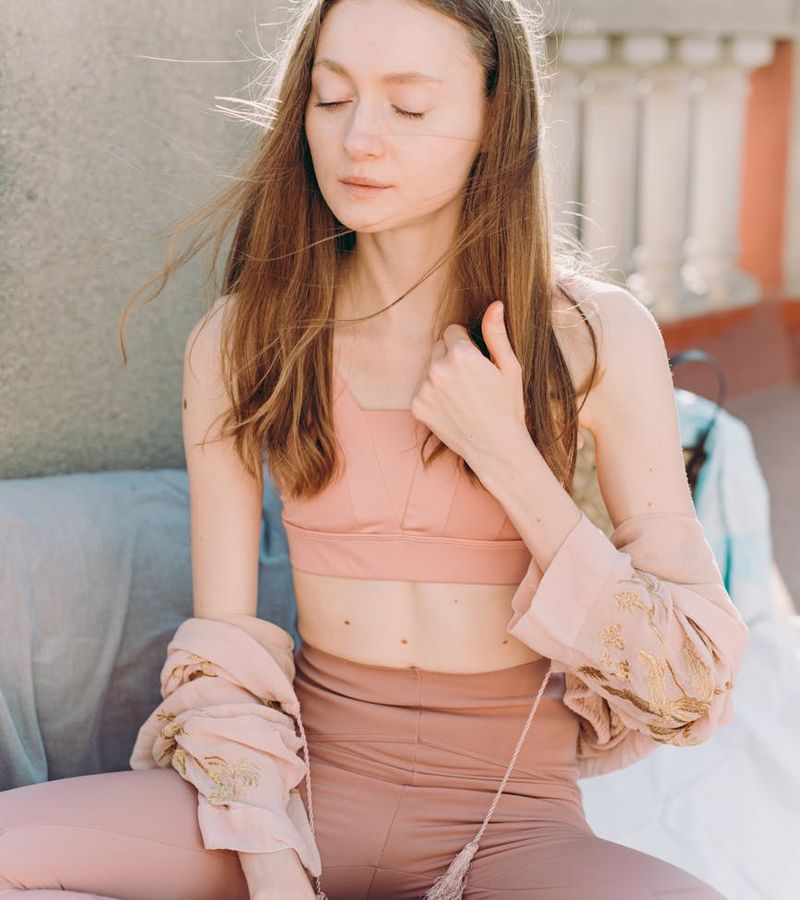 Woman in a state of deep relaxation during a yoga practice, phlox colored tones.